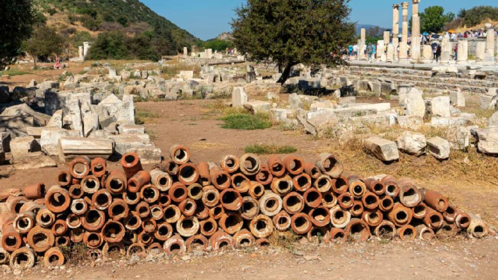 Ancient Roman pipes discarded in a pile at a ruin site