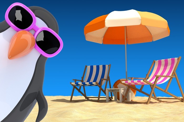 Cartoon penguin at the beach